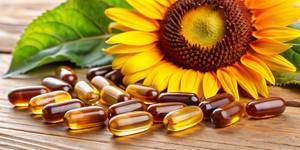 Lecithin-Kapseln-Test: Vor einer Sonnenblume liegen mehrere Lecithin-Kapseln. 