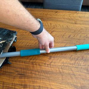 Eine Hand zieht den Griff aus dem Karton des Leifheit 55238