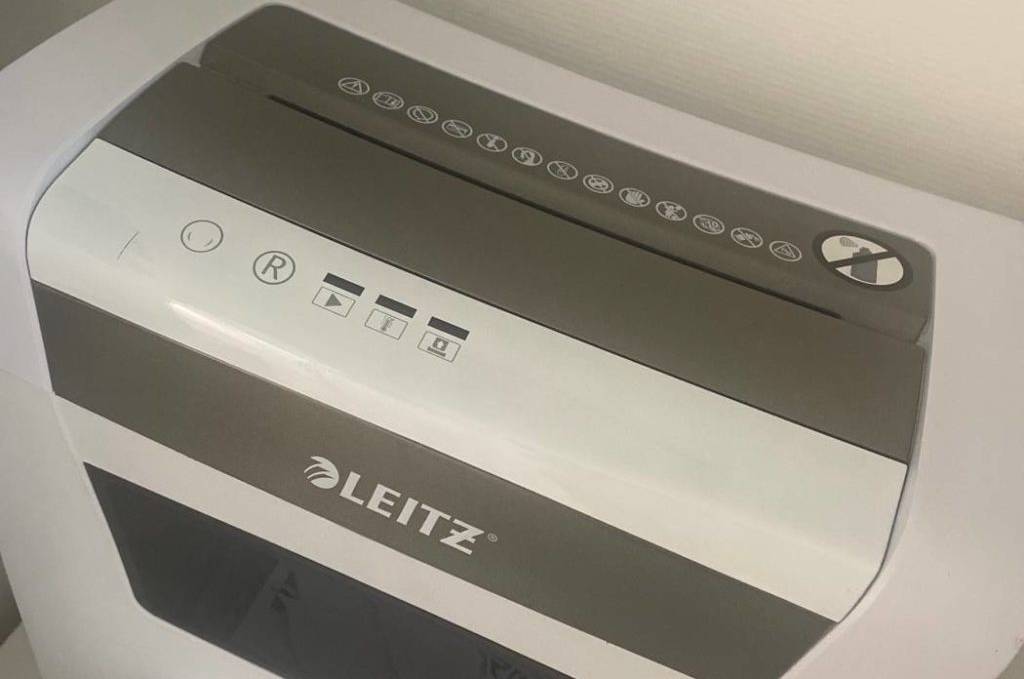 Aktenvernichter-Test: Ansicht von schräg oben vor weißer Wand eines weißen Leitz-Aktenvernichters mit grauen Design-Elementen.