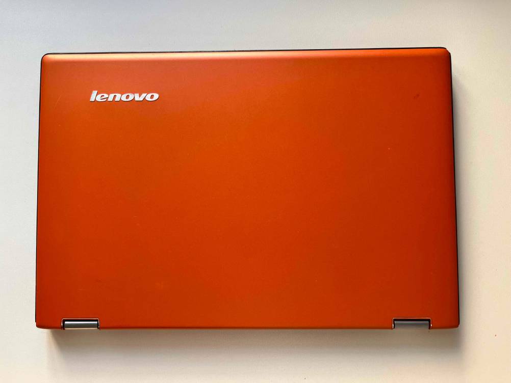 Ein getestetes Lenovo Yoga zusammengeklappt von oben auf einer hellen Fläche.