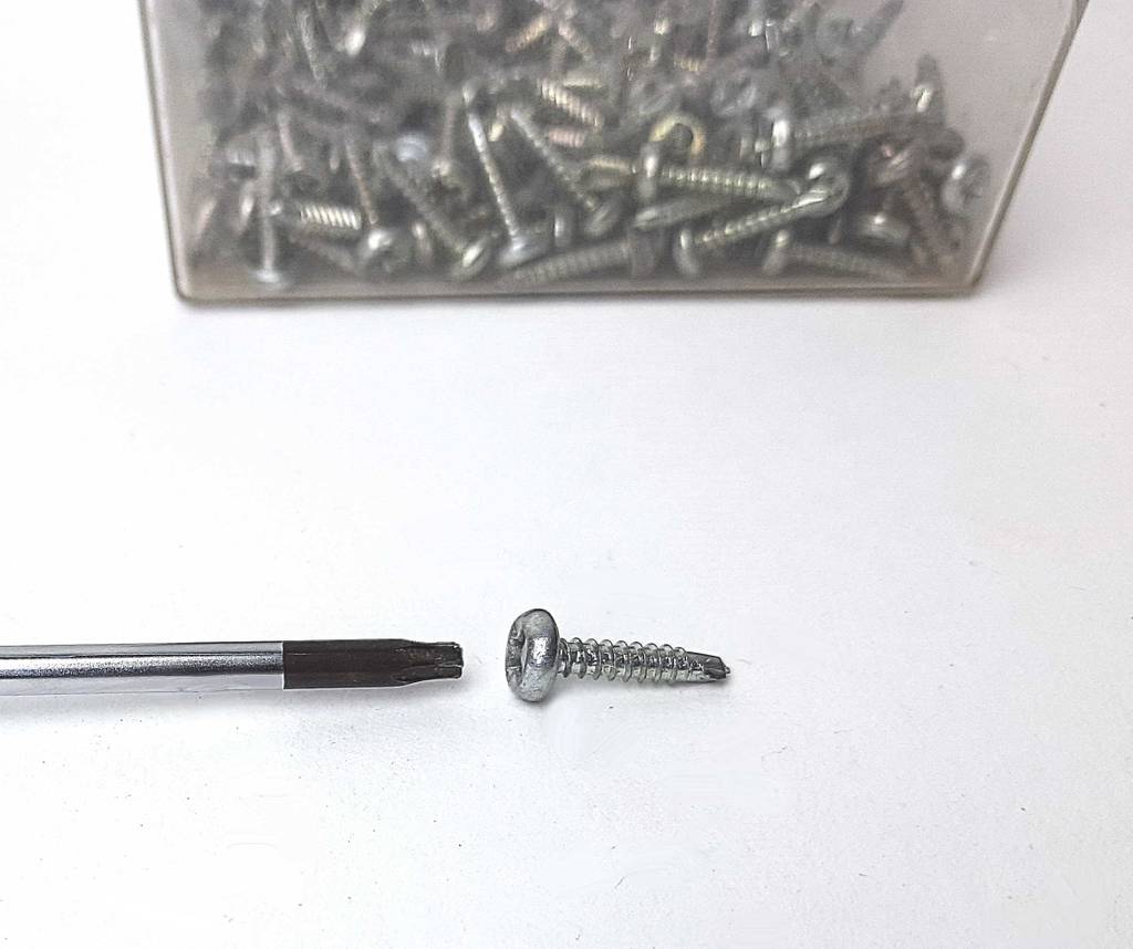Schraubendreher im Test: Ein Kreuzkopf vor einer Dose mit Schrauben.