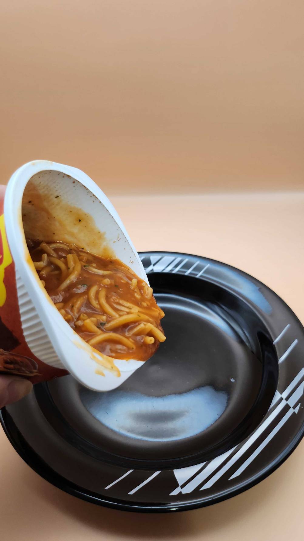 Getestet: Eine Maggi-5-Minuten-Terrine wird auf einem schwarzen Teller gegeben.