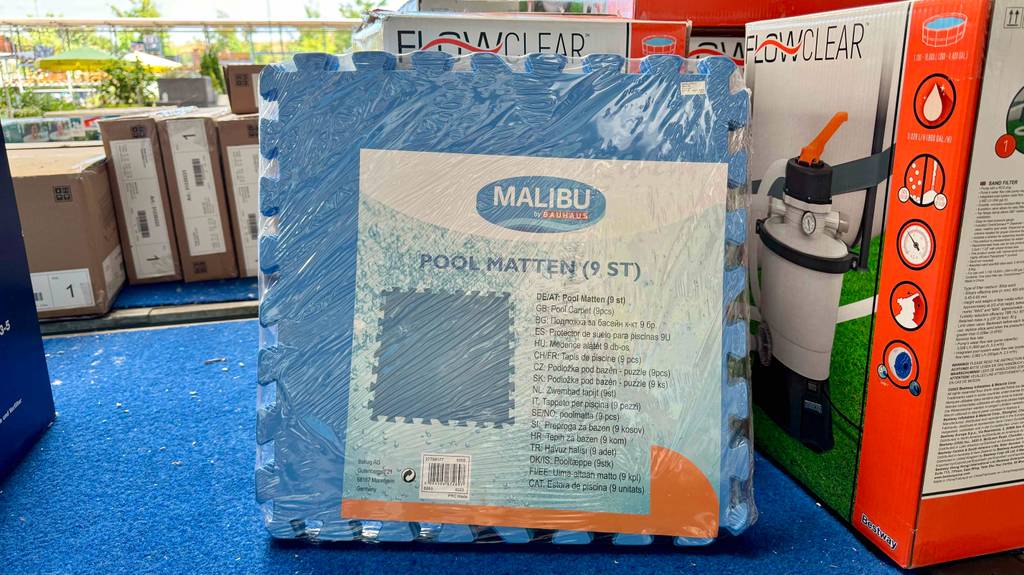 Eine verpackte Pool-Unterlage steht zum Testen neben anderen Geräten.