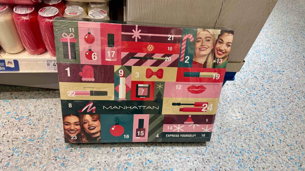 Adventskalender für Frauen im Test: Ein Kalender steht vor einem Kerzenregal auf dem Boden.