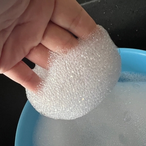 Schaum hängt an einer Hand.