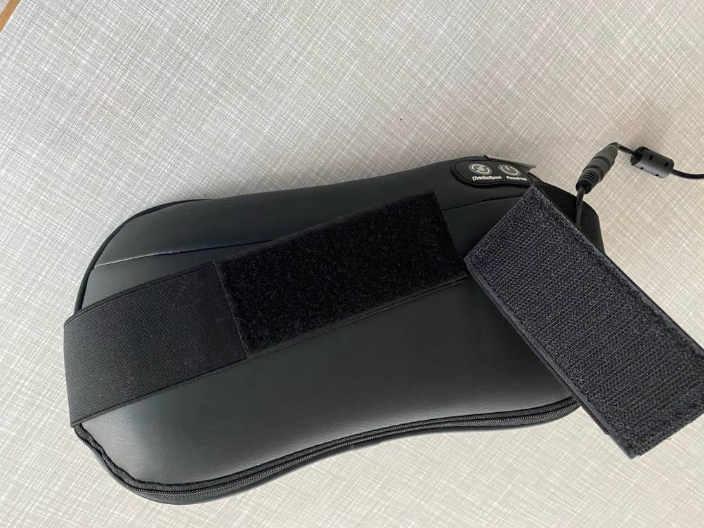 Rückseite eines getesteten Massagegerätes mit Fokus auf den Klettverschluss.