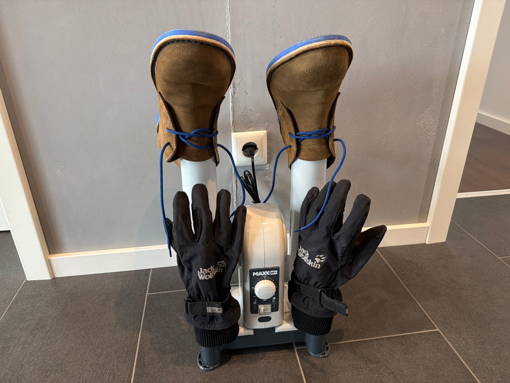 Zwei Schuhe und zwei Handschuhe werden mit dem MaxxDry-Hochleistungstrockner getrocknet