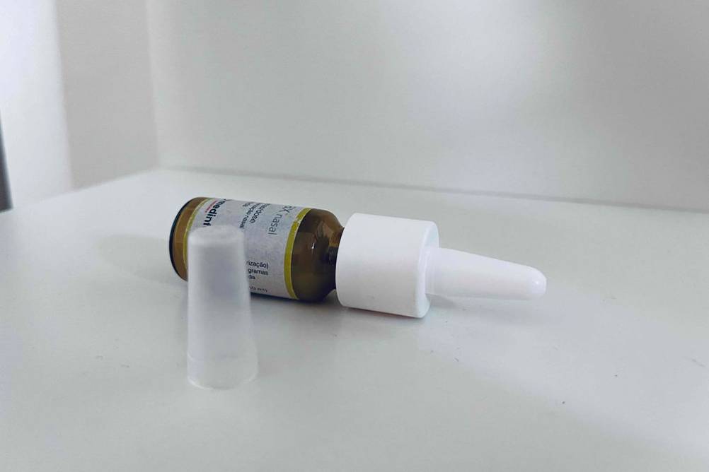 Allergie-Nasenspray-Test: kleiner Flacon mit Medinfar-Aeromax-Nasal liegt geöffnet neben der Verschlusskappe auf einer hellen Oberfläche.