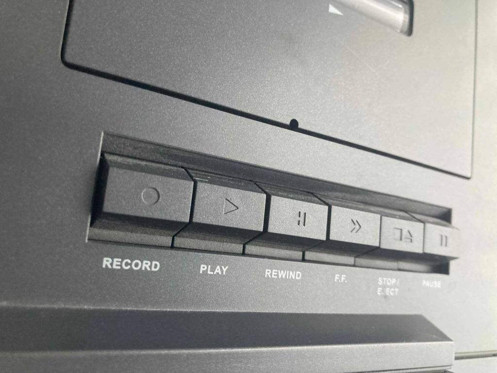 Bedientasten eines grauen CD-Players mit Kassettendeck im Test.