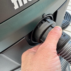 Eine Hand befestigt den Schlauch am Metabo ASR 25 L SC