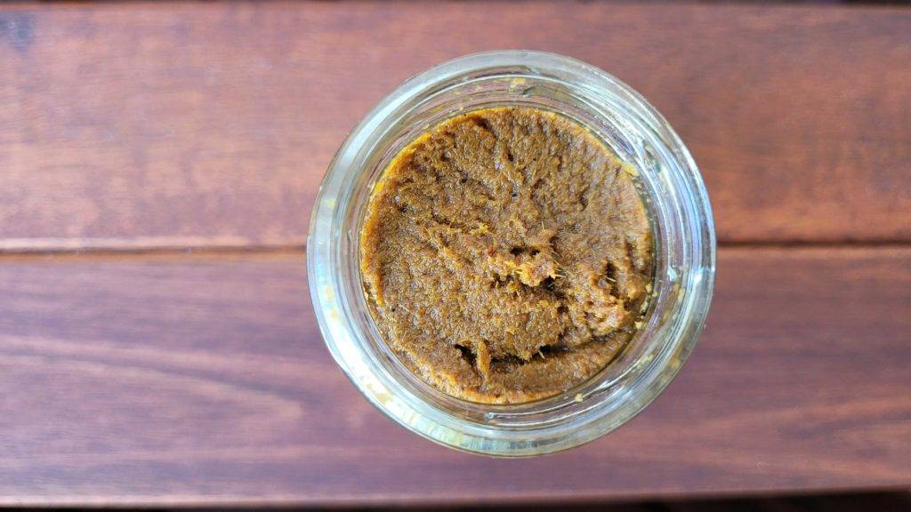Geöffnete gelbe Currypaste Ming Chu im Glas.