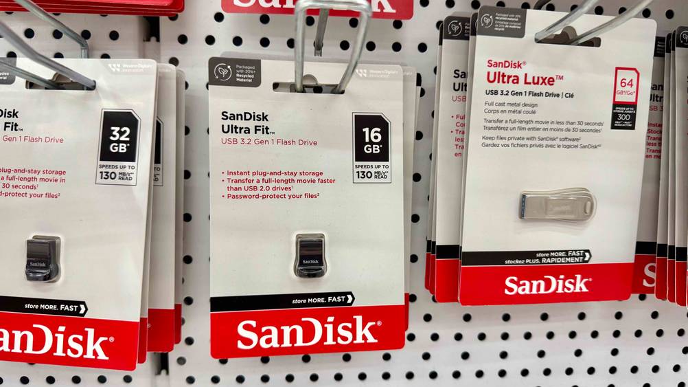 In einem Regal hängen mehrere verpackte Mini-USB-Sticks im Test.