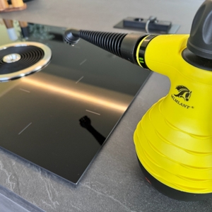 Der Mlmlant-Handgerät-Dampfreiniger steht neben einem Herd