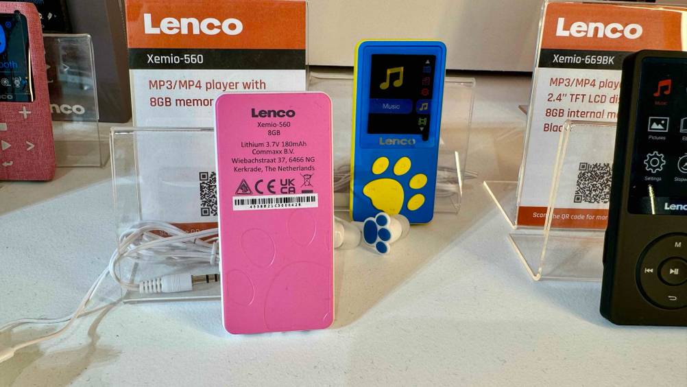 Ein MP3-Player für Kinder im Test steht mit der Rückseite nach vorne in einem Regal mit andere Produkten.