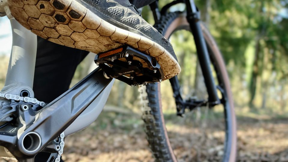 Ein Mountainbike-Schuh steht auf dem Gewage USGE323 Pedal. Die breite Plattform mit Metallpins sorgt für stabilen Halt.