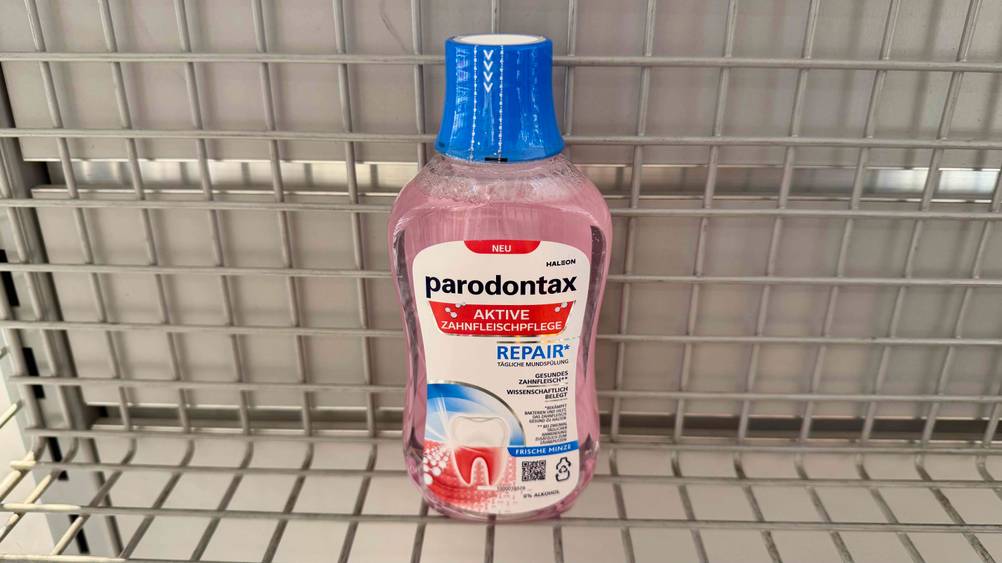 Mundspülung gegen Zahnfleischentzündung im Test: Eine Flasche in einem Gitterregal.
