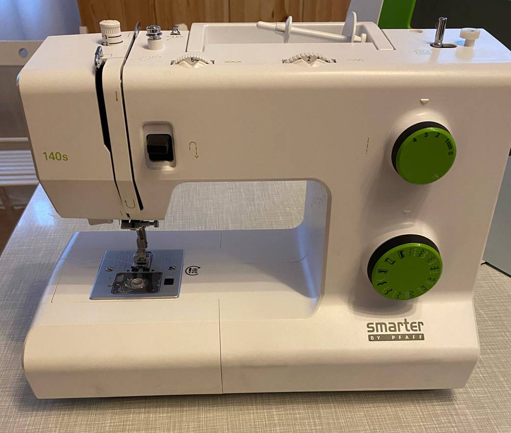 Seitenansicht einer Nähmaschine im Test auf einem Tisch.