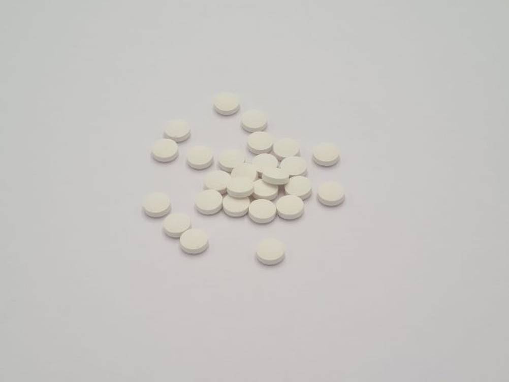 biotin-test: Auf einem Tisch liegen mehrere Biotin-Tabletten. 