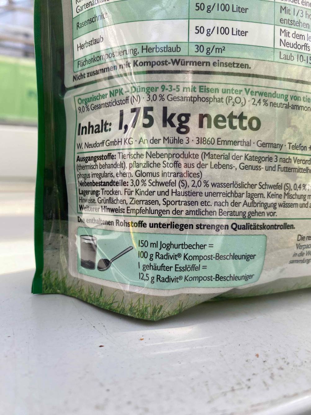 Nahaufnahme der Inhaltsangabe auf der Rückseite einer Packung Kompostbeschleunigers im Test.