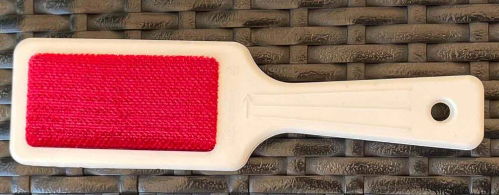 Detailansicht des roten Reinigungsmaterials einer getesteten Fusselbürste.