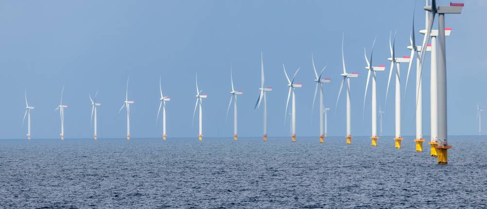 Test der Anbieter von Ökostrom: Mehrere Windräder stehen im Meer und bilden einen Windpark.