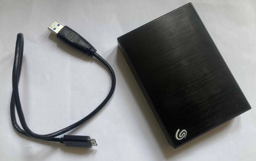 Im Test: Eine externe Festplatte mit 5 TB Speicherplatz liegt neben einem USB-Kabel.