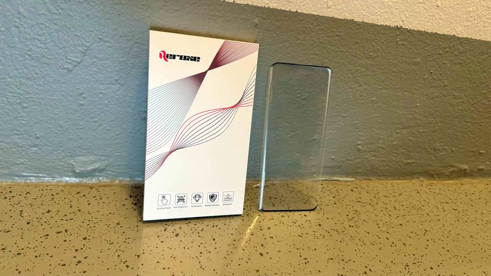 OnePlus-8-Pro-Panzerglas getestet: An einer Wand lehnt ein Glas neben der Verpackung.