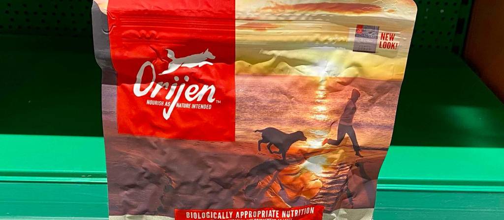 Eine rötliche wiederverschließbare Verpackung mit Orijen Hundefutter im Test, mit Fokus auf dem Markenzeichen.