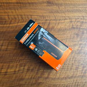 Der Karton vom Osram TyreInflate 2000 liegt auf einem Holztisch