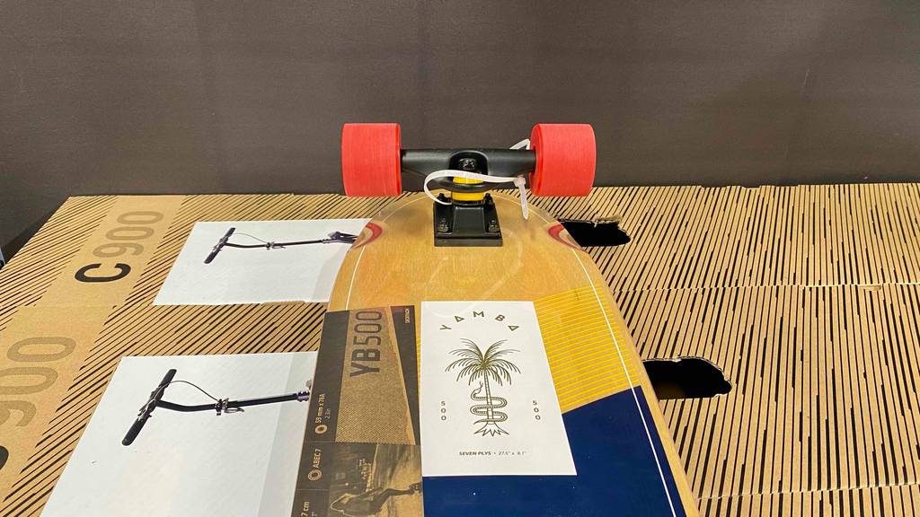 Im Test: Auf einem halb sichtbaren Longboard, das auf der Standfläche liegt, ist der Markenaufkleber angebracht.