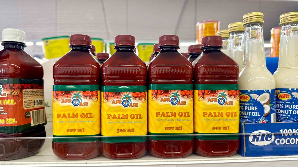 Mehrere Flaschen des getesteten Palmöls nebeneinander in einem Verkaufsregal neben anderen Produkten.