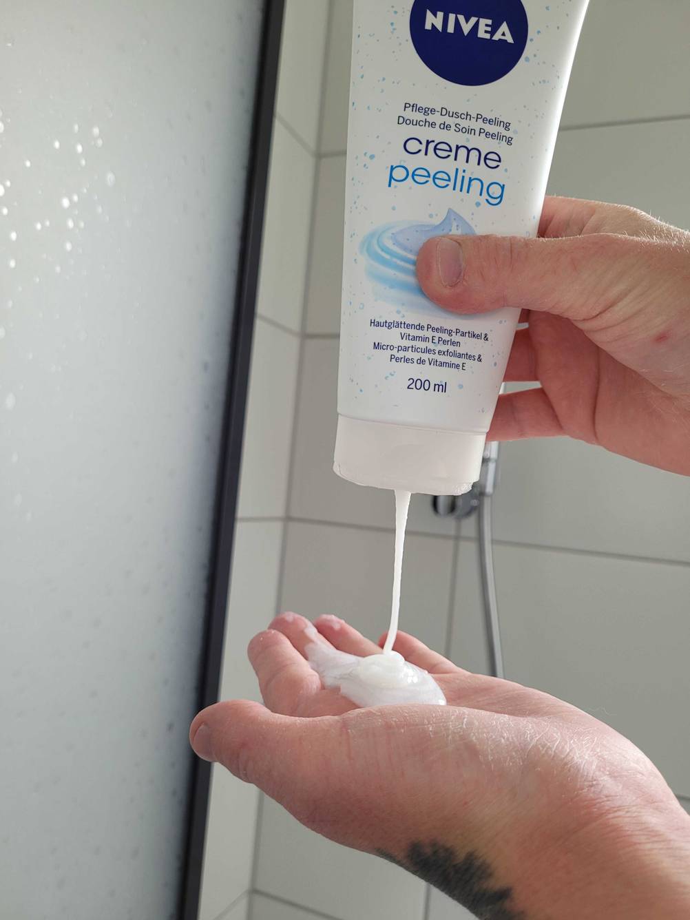 Eine Hand drückt sich Peeling im Test in die Handfläche.