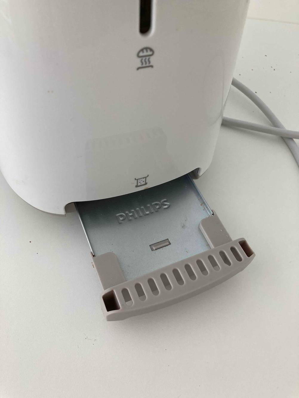 Blick von oben auf die geöffnete Krümelschublade eines Philips-Toasters im Test.