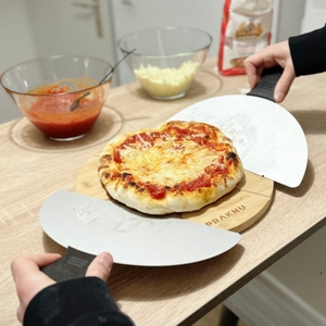 Eine fertige Pizza wird auf einem Holzbrett serviert.