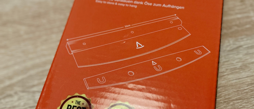 Die Rückseite der Verpackung des Pizzaschneiders von Pizza Mondo im Detail.