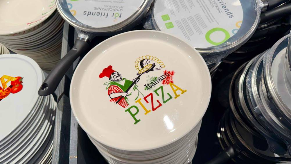 Pizzateller im Test: Mehrere Teller übereinander zwischen Töpfen.