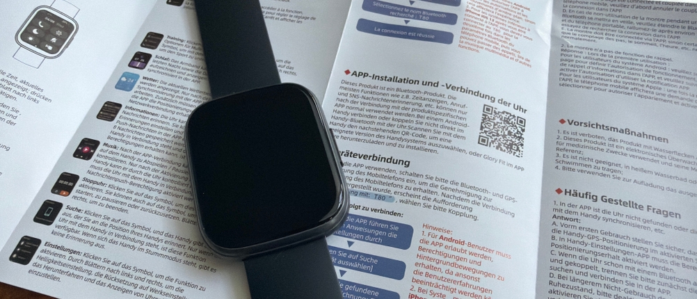 Die Poounur-T80-Smartwatch liegt auf der Anleitung