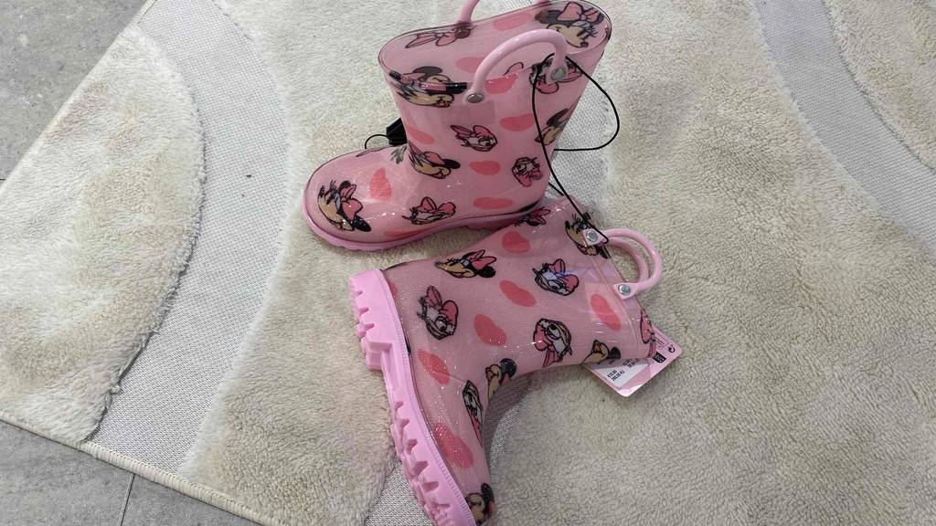 Gummistiefel-Kinder-Test: ein Paar tragbare, rosafarbene Gummistiefel mit Micky Maus Aufdruck von oben betrachtet.
