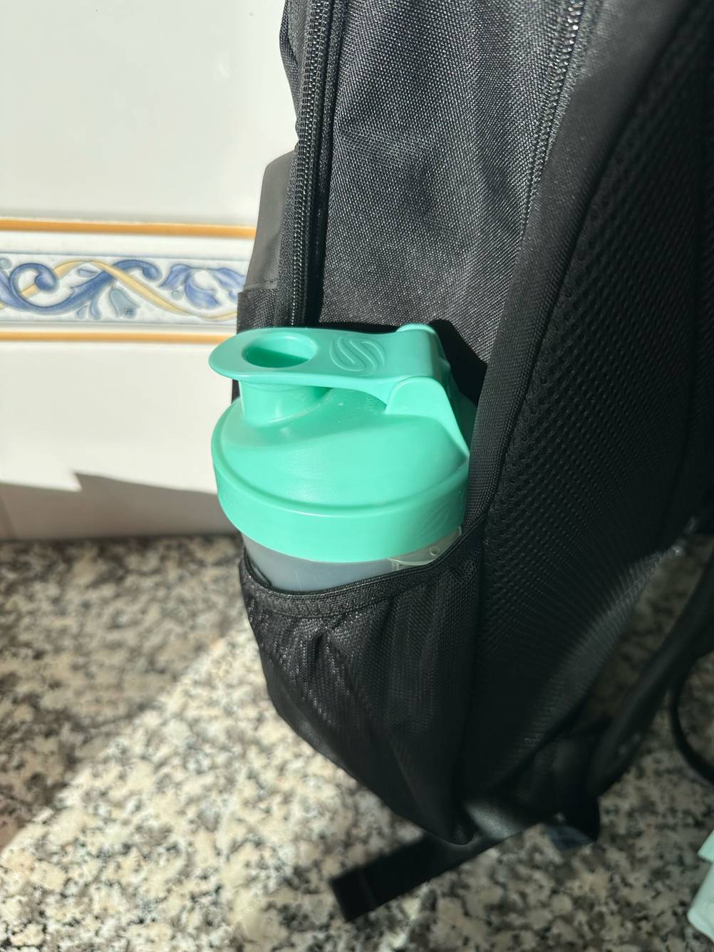 Ein getesteter Eiweiß-Shaker ist in einer Rucksackaußentasche verstaut.