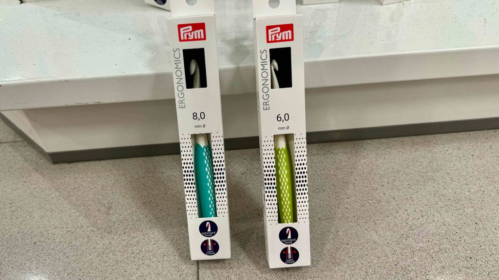 Zwei unterschiedlich große tunesische Häkelnadeln im Test befinden sich in ihren Verpackungen.