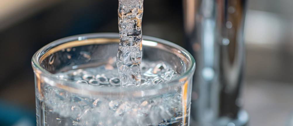 Quooker-Test: Wasser fließt aus Hahn direkt in ein Glas.