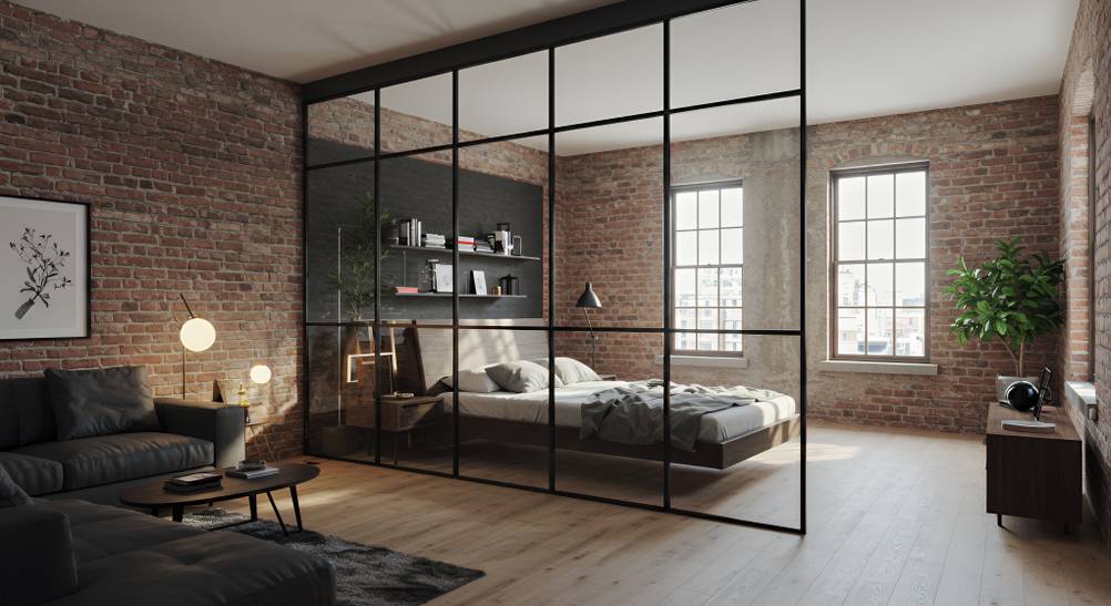 Raumtrenner-Test: Eine Loft-Glaswand dient als Raumtrenner zwischen einem Wohn- und Schlafbereich.