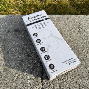 Der Karton des Reezer RS1 liegt auf einem Stein.