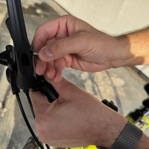 Eine Hand befestigt die Halterung des Reezer RS1 mit einem Innensechskantschlüssel.