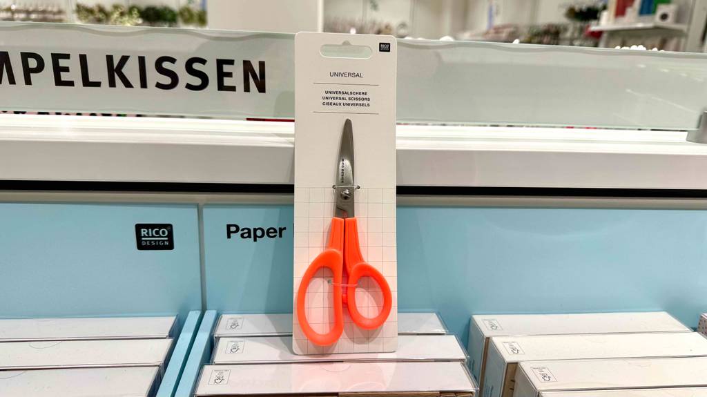 Eine getestete Schere inklusive Verpackung steht in einem Verkaufsbereich.