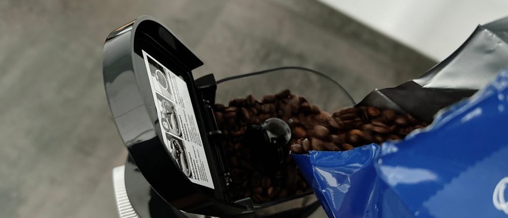 Kaffeemühlen im Test: eine EKM200 von Rommelsbacher wird mit Bohnen befüllt.