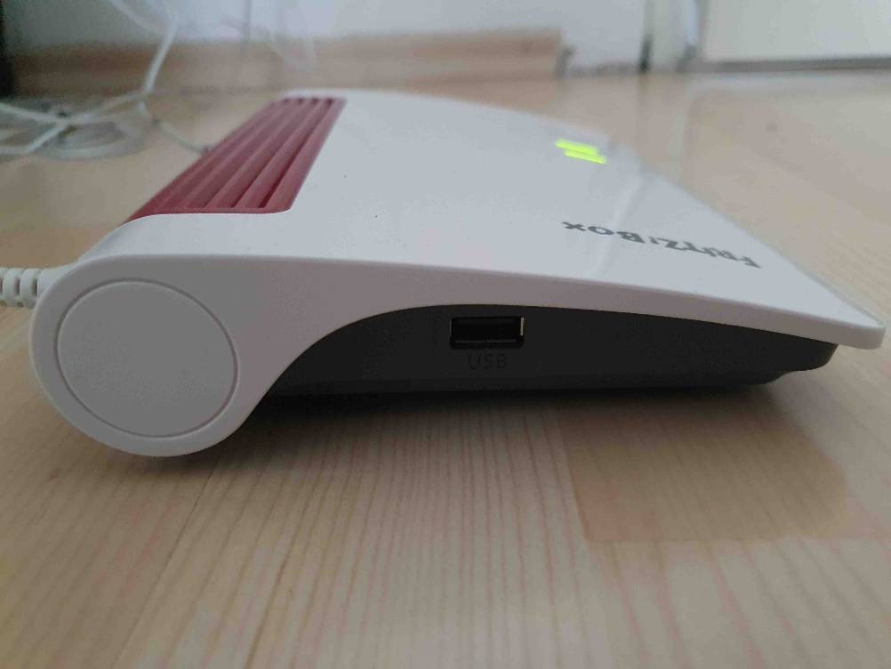 Router getestet: Seitenansicht des Gerätes auf einer Holzfläche.