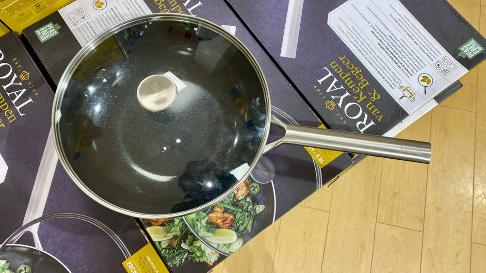 Gesamtansicht von oben eines mit Glas-Deckel geschlossenen, getesteten Woks von Royal, der sich auf seiner Verpackung befindet.