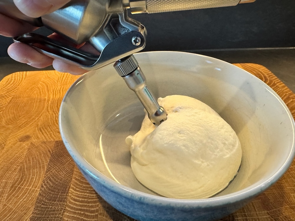 Sahne wird mit dem RuneSol-Sahnespender in eine Schale gesprüht