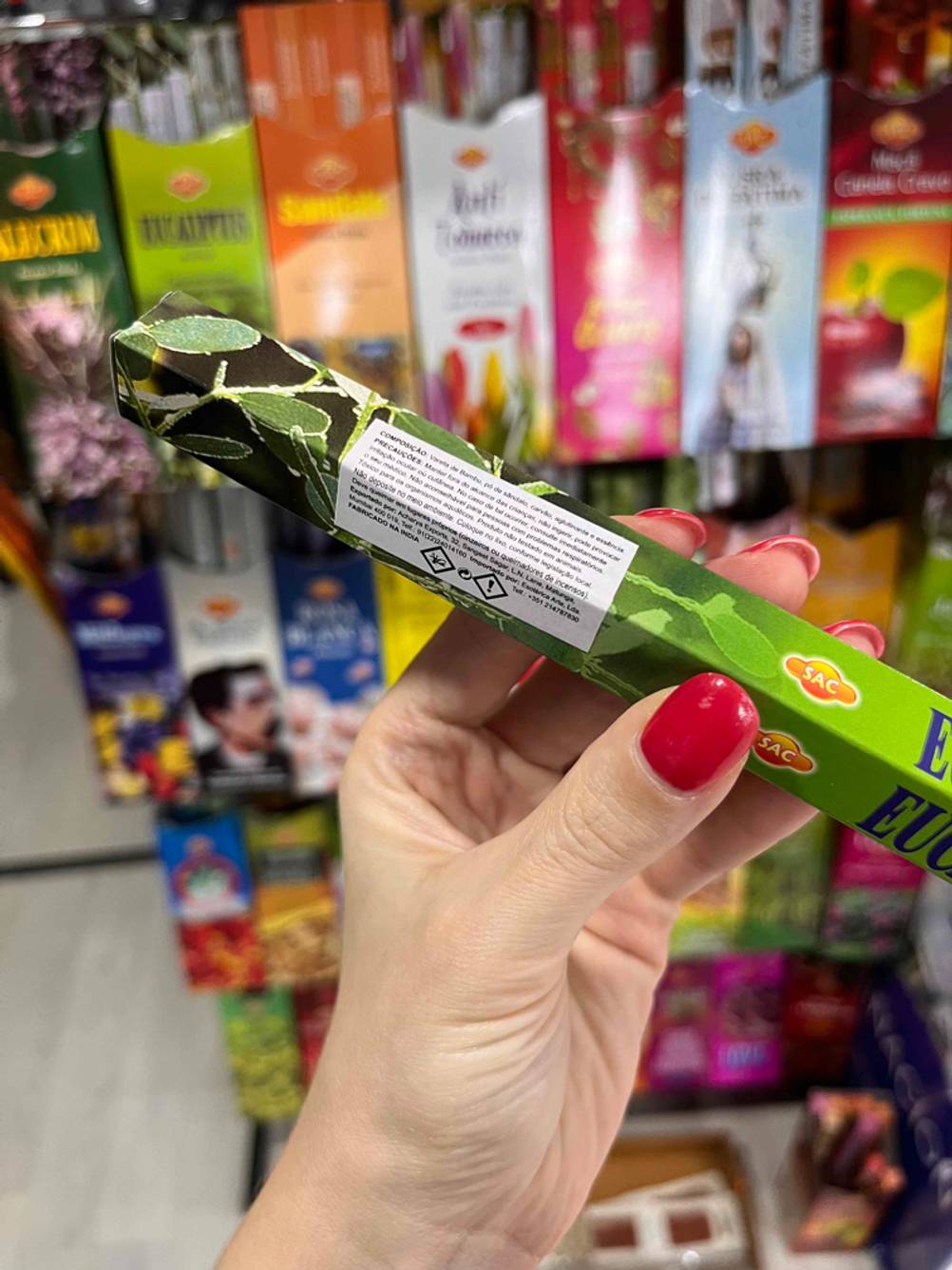 Getestet: Detailaufnahme Gefahreninformationen auf der Rückseite einer Packung Räucherstäbchen, die von einer Hand gehalten wird.